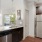 a kitchen with a stainless steel refrigerator