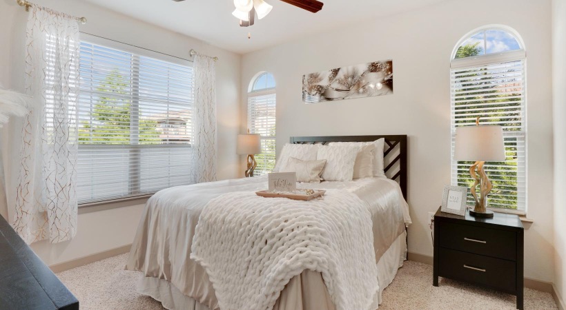 a bedroom with a bed and a fan